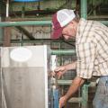 William White works to install pig-handling equipment in a multipurpose building being readied for swine nutrition research at Mississippi State University's H.H. Leveck Animal Research Center. (Photo by MSU Ag Communications/Scott Corey)