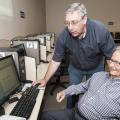 As part of an ongoing program of computer skills workshops, John Giesemann with the Mississippi State University Extension Service Center for Technology Outreach shows Vern Boothe how to access a slideshow program at the WIN Job Center in Madison on July 9, 2013. (File photo by MSU Ag Communications/Scott Corey)