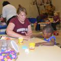 Gina Carr, a Mississippi State University Extension Service staff member with the Mississippi Child Care Resource and Referral Network, keeps 3-year-old Brandily Haynes engaged while his family is in the American Red Cross Shelter at First Baptist Church in Louisville, Mississippi, on May 1, 2014.  (Photo by MSU Ag Communications/Linda Breazeale)