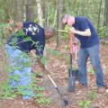 Navy Chief Contrail Allen, left, and Navy Chief Ryan Done plant a Bigleaf Magnolia on the Arrival Journey Exhibit at the Crosby Arboretum on May 8. About 20 Navy volunteers from the Stennis Space Center helped repaint the entrance gates, prune vegetation along the trails and construct part of the new Swamp Forest Education Exhibit. (Photos by Susan Collins-Smith)