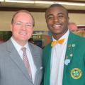 MSU President Mark Keenum stands next to a young man in a green 4-H blazer.