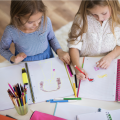 Two girls coloring. 