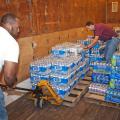 B.J. McClenton, Monroe County Extension coordinator (left), and Charlie Stokes, area Extension agent, unload water from a semi-trailer to distribute to tornado victims in Monroe County in 2011. (Photo by MSU Ag Communications/Scott Corey)