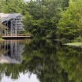 The Pinecote Pavillion stands in the background of the pond at the Crosby Arboretum.