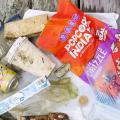 An assortment of litter retrieved from a watershed displayed on a wooden dock. 