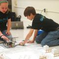 Lillian Stewart and Thaddeus Webb, members of The Mean Machines 4-H robotics team in Rankin County, practice with their robot before afternoon competition at the Southwest District 4-H Project Achievement Day held at Hinds Community College in Raymond, Mississippi. Junior 4-H members, ages 8 to 13, participated in contests on a variety of topics, including foods and nutrition, engineering, and meat and dairy judging on June 6, 7, 12 and 13. (Photo by MSU Ag Communications/Susan Collins-Smith)