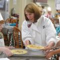 Laura Brumbaugh (center), Mississippi State University Extension Service agent in Tate County, helps Harlan Tagert, left, and Walt Giesen, both of Starkville, finish their quiches on June 21, 2016, at the MSU Fun with Food Camp. The annual summer camp offers hands-on training and educational field trips for 3rd- to 6th-grade children to learn about nutrition, cooking and food safety. (Photo by MSU Extension Service/Michaela Parker) 