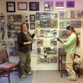 Crosby Arboretum membership coordinator Kimberly Johnson and senior curator Richelle Stafne update a display showcasing gardens that participate in a reciprocal admissions program. Crosby Arboretum members can tour more than 100 botanical gardens and historic homes across the United States for free with their paid local membership. (Photo by MSU Extension Service/Patricia Drackett)