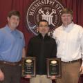 The Mississippi Agricultural and Forestry Experiment Station recently honored Mississippi State University scientists and students for outstanding research. Fei Yu, center, received the 2014 Excellence in Research Award. Tyler Anderson, left, and Bart Harris represent Mississippi Land Bank, which sponsored the award. (Photo by MSU Ag Communications/Kat Lawrence) 