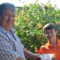 Mississippi State University Extension Service beekeeping specialist Jeff Harris presents 4-H'er Garrett Smith of Starkville, Miss. with the state- and national-level awards for the 4-H Honey Bee Essay Contest. The presentation was made May 7, 2014 at MSU. (Photo by MSU Ag Communications/Keri Collins Lewis)