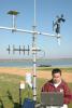 Mark Silva, an Extension associate with the Delta Agriculture Weather Center, checks catfish pond water temperatures. (Photo/ Robert H. Wells)