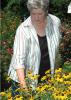 Rankin County Master Gardeners president Nellie Axley of Brandon admires the refurbished flower bed the group created for the local Extension office landscape.