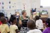 Melissa Tenhet, project director for the Mississippi Child Care Resource and Referral Network shares a story with the preschool students at the Brickfire Project after completing literacy pre-assessments through Starkville Rotary's community service project. (Photo by MSU Extension Service/Alicia Barnes)