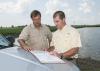 Jeremy Jack, left, and Mississippi State University professor Robbie Kroger discuss some of the conservation methods employed on the Silent Shade Planting Company in Belzoni. (Photo by MSU Ag Communications/Scott Corey)