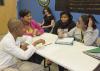 The Alpha Kappa Alpha Sorority at Mississippi State University has partnered with the MSU Extension Service to enhance educational opportunities available to students at the Boys and Girls Club of Starkville. At the head of the table, Donae Reggans, sales and marketing administrator for Gulf States, talks with Timothy Guy (from left around the table), Aleah Graham and Celeiah Quin. (Photo by MSU Ag Communications/Kevin Hudson)