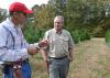 Christmas tree producer Don Kazery Jr., left, discusses agricultural practices on his Hinds County farm with Stephen Dicke, a forestry professor with the Mississippi State University Extension Service, on Nov. 6, 2014. Harsh weather conditions in 2014 and several years of high demand reduced the number of trees available in heavily populated counties. (Photo by MSU Ag Communications/Susan Collins-Smith)