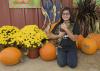 Katy Chen of Louisville, Mississippi, holds the unofficial mascot of May’s Corn Maze in Stewart, Mississippi, in front of the agritourism farm’s pumpkin patch. The state enjoyed a strong pumpkin harvest for the second straight year. (Photo by MSU Extension Service/Kevin Hudson)