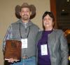 Rocky Lemus receives a merit award from Yoana Newman, a member of the American Forage and Grassland Council Board and Foundation Board, during the recent annual conference in Memphis on Jan. 14, 2014. (Photo by Virginia Tech/Chris Teutsch)