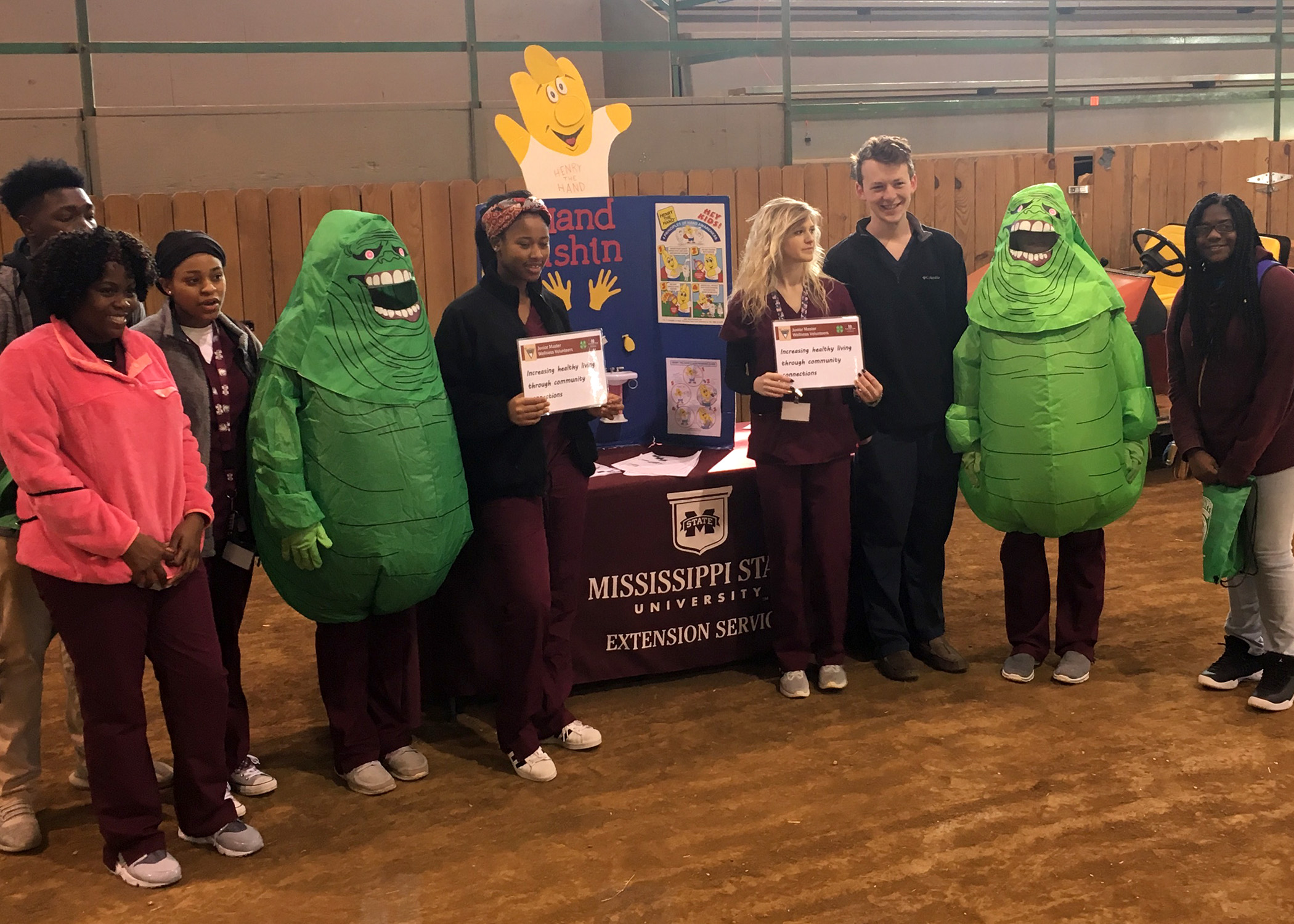 Jr Master Wellness Volunteers  are discussing the importance of drinking water as opposed to sugary drinks.